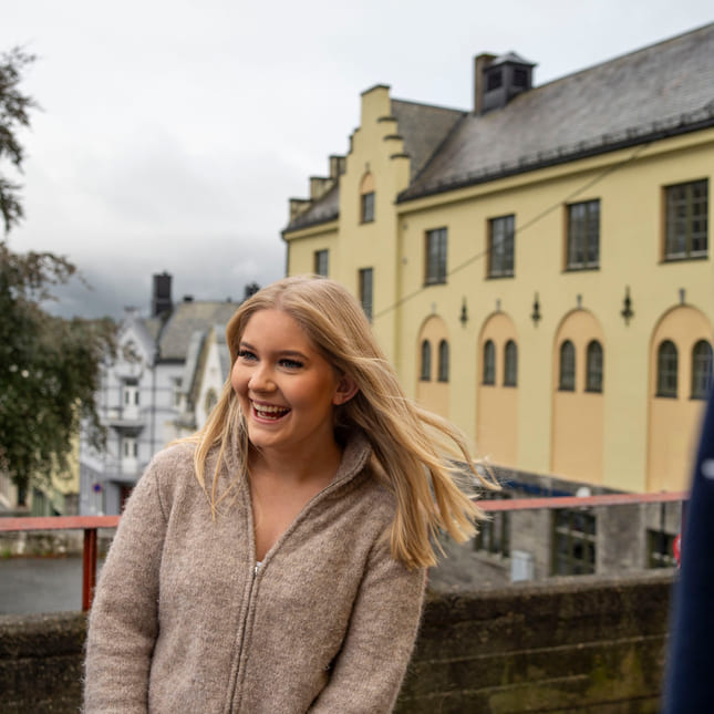 Elev smiler utenfor Parkgata Akademiet VGS Ålesund