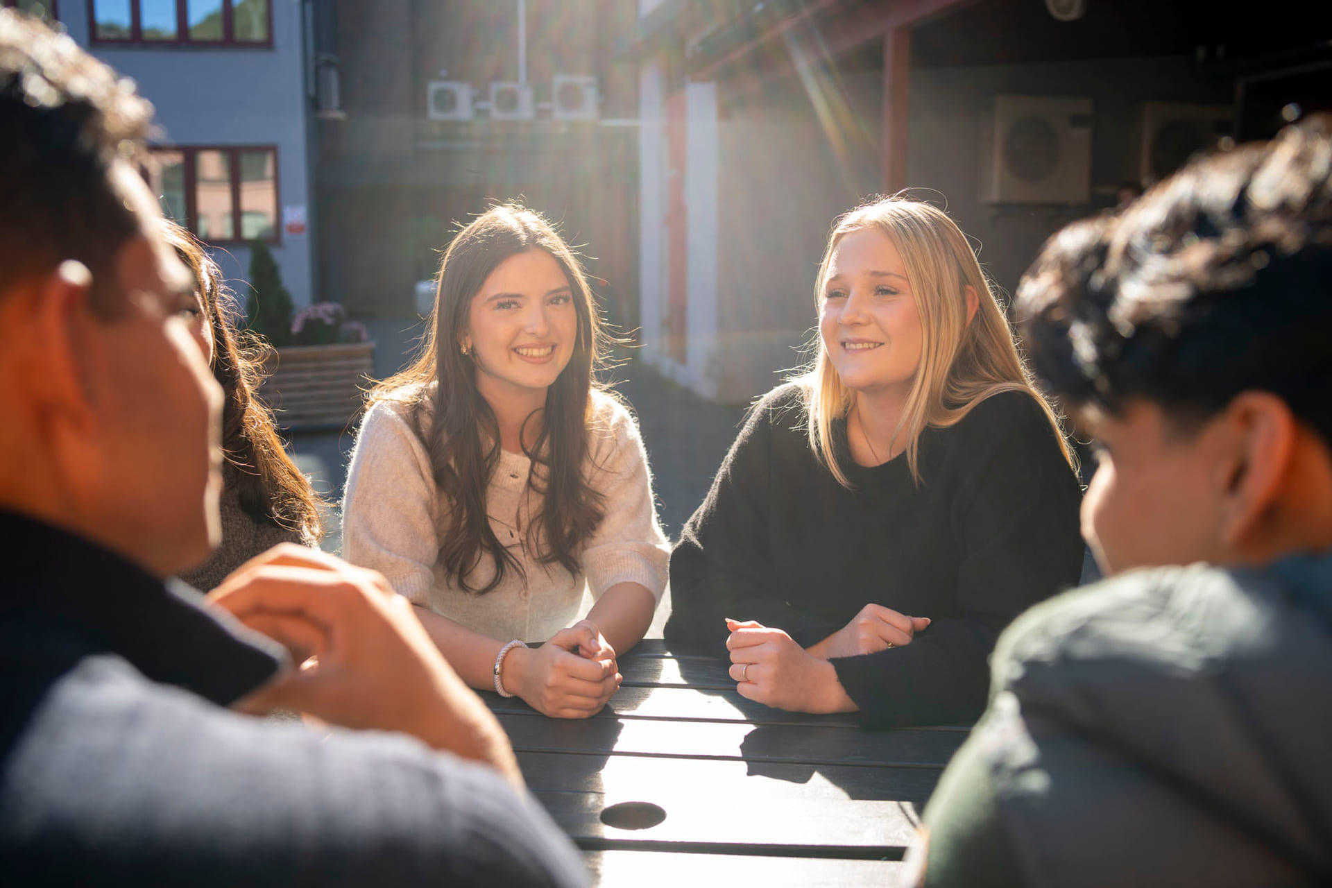 Elever sitter utenfor Akademiet VGS Ypsilon