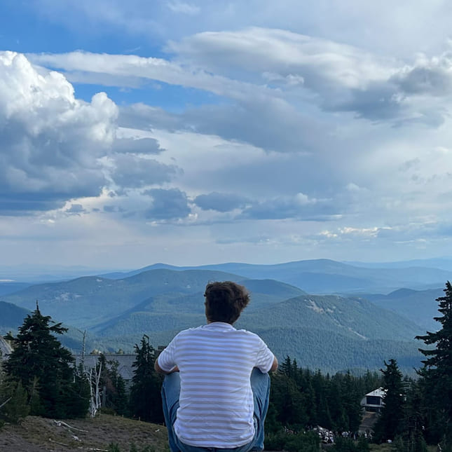 Gutt sitter på huk og kikker på utsikten i USA.