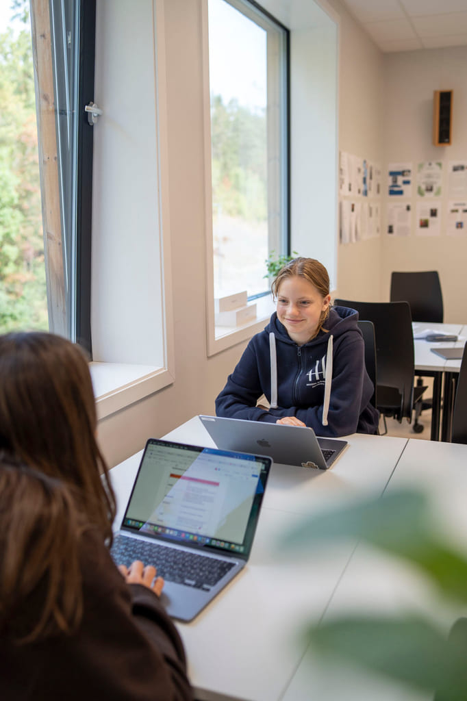 To elever snakker sammen i studietid på Akademiet Ungdomsskole Asker